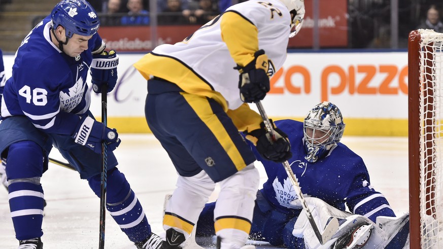 Nashville Predators left winger Kevin Fiala (22) looks for the puck in front of Toronto Maple Leafs goaltender Frederik Andersen (31) as Leafs defenseman Roman Polak (46) watches during the third peri ...