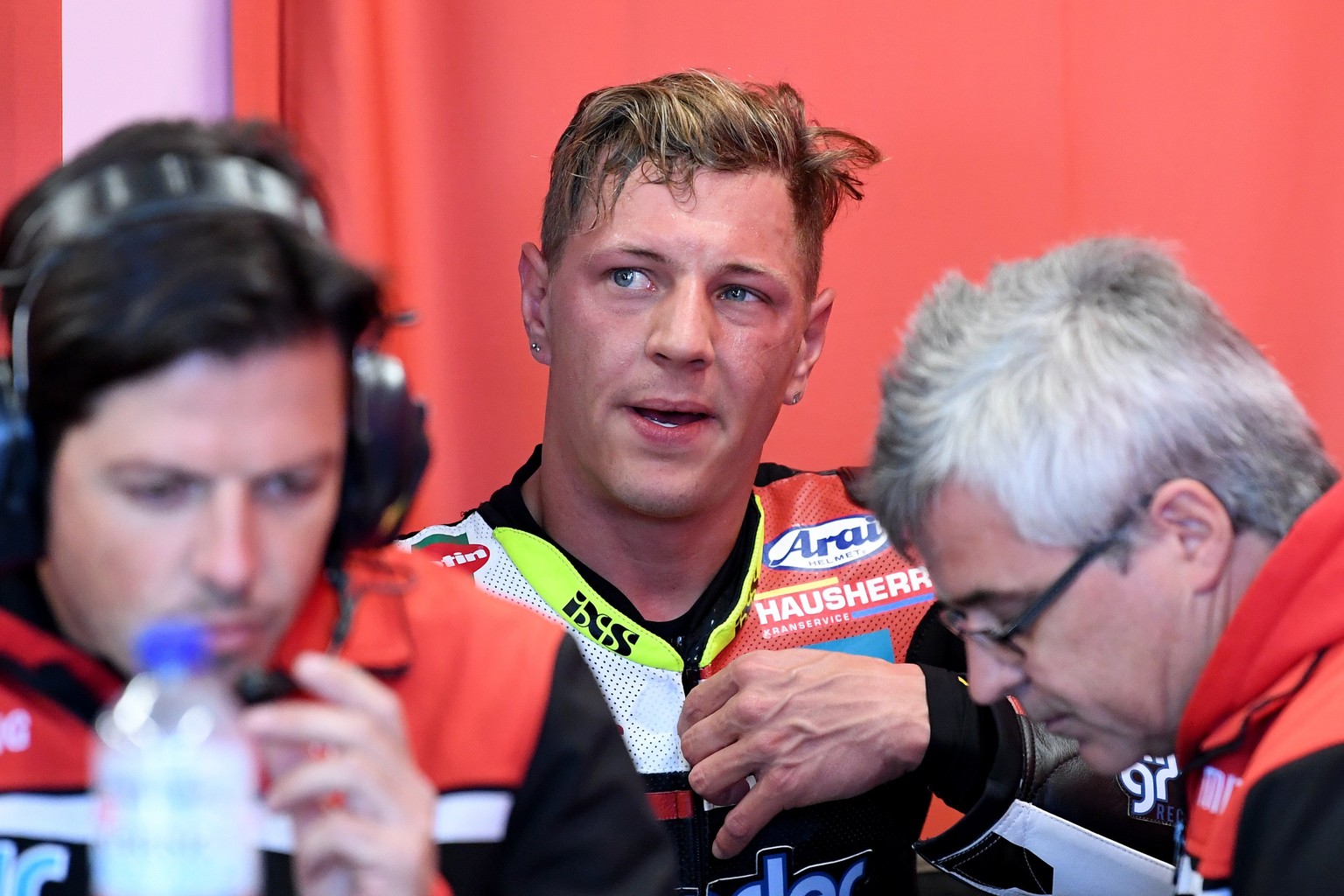 epa06277530 Swiss Moto2 rider Dominique Aegerter (C) of the Kiefer Racing team speaks with team officials during free practice of the Australian MotoGP Grand Prix 2017 on Phillip Island, Victoria, Aus ...