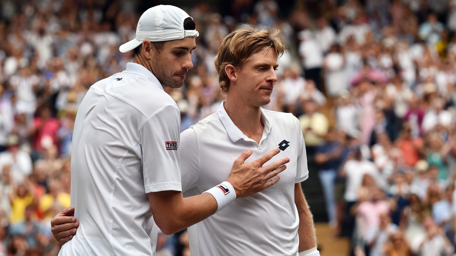 epa06886566 Kevin Anderson of South Africa (R) at the net with John Isner of the US whom he defeated in their semi final match during the Wimbledon Championships at the All England Lawn Tennis Club, i ...