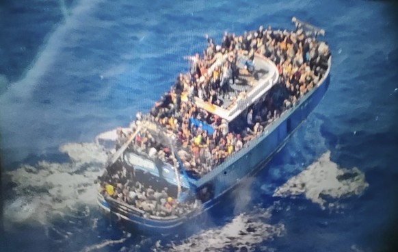FILE - This undated handout image, provided by the Hellenic Coast Guard on Wednesday, June 14, 2023, shows dozens of people on a battered fishing boat that later capsized and sank off the coast of southern Greece.  ...