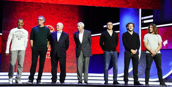 epa06359727 Draw assistants (L-R), Cafu, Laurent Blanc, Nikita Simonyan, Gordon Banks, Fabio Cannavaro, Diego Forlan, and Carles Puyol pose for photographers on stage on the eve of the FIFA World Cup  ...