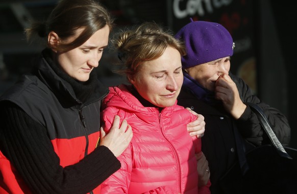 Relatives of the victims of a crashed Russian airliner with 217 passengers and seven crew aboard, help each other as they gathering at Pulkovo airport in St.Petersburg, Russia, Saturday, Oct. 31, 2015 ...