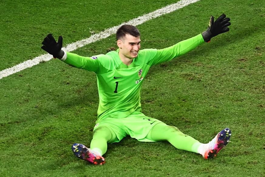 epa10350096 Goalkeeper Dominik Livakovic of Croatia celebrates saving a penalty taken by Maya Yoshida of Japan during the FIFA World Cup 2022 round of 16 soccer match between Japan and Croatia at Al J ...