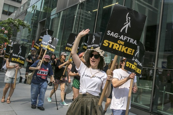 epa10752118 People picket outside of HBO and Amazon offices in New York, New York, USA, 17 July 2023. Writers Guild of America members have been on strike since early May as agreements between the All ...