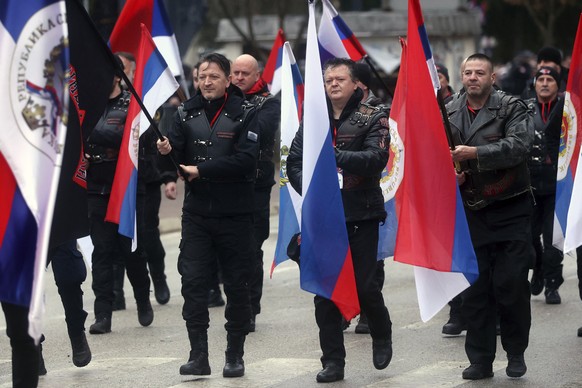 Local members of the Russian Night Wolves Motorcycle Club march in a parade celebrating the 31st anniversary of the Republic of Srpska in Istocno Sarajevo, Bosnia, Monday, January 9, 2023. Thousands of flags…