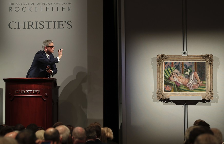 Global president of Christie&#039;s Jussi Pylkkanen taps the gavel on the podium for the final sale of Henri Matisse&#039;s &quot;Odalisque couchee aux magnolias&quot; for $71.5 million during an auct ...