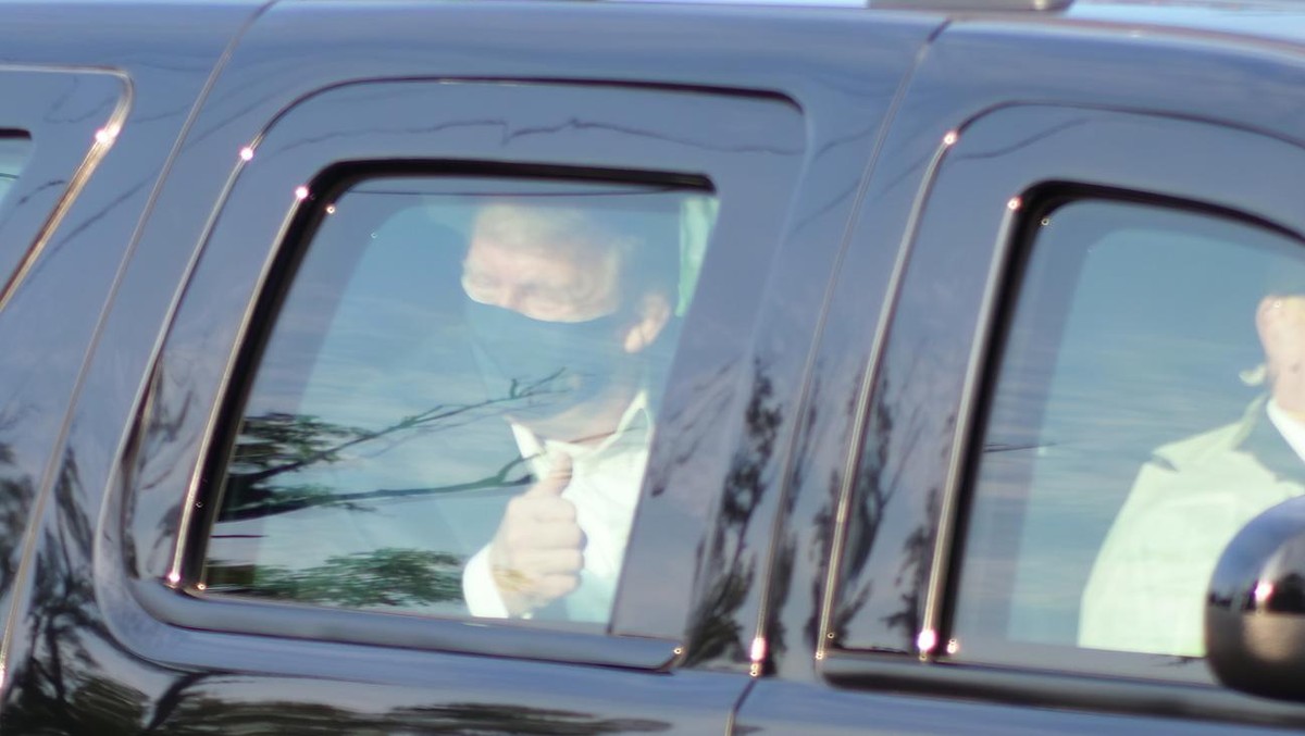 President Donald Trump drives past supporters gathered outside Walter Reed National Military Medical Center in Bethesda, Md., Sunday, Oct. 4, 2020. Trump was admitted to the hospital after contracting ...