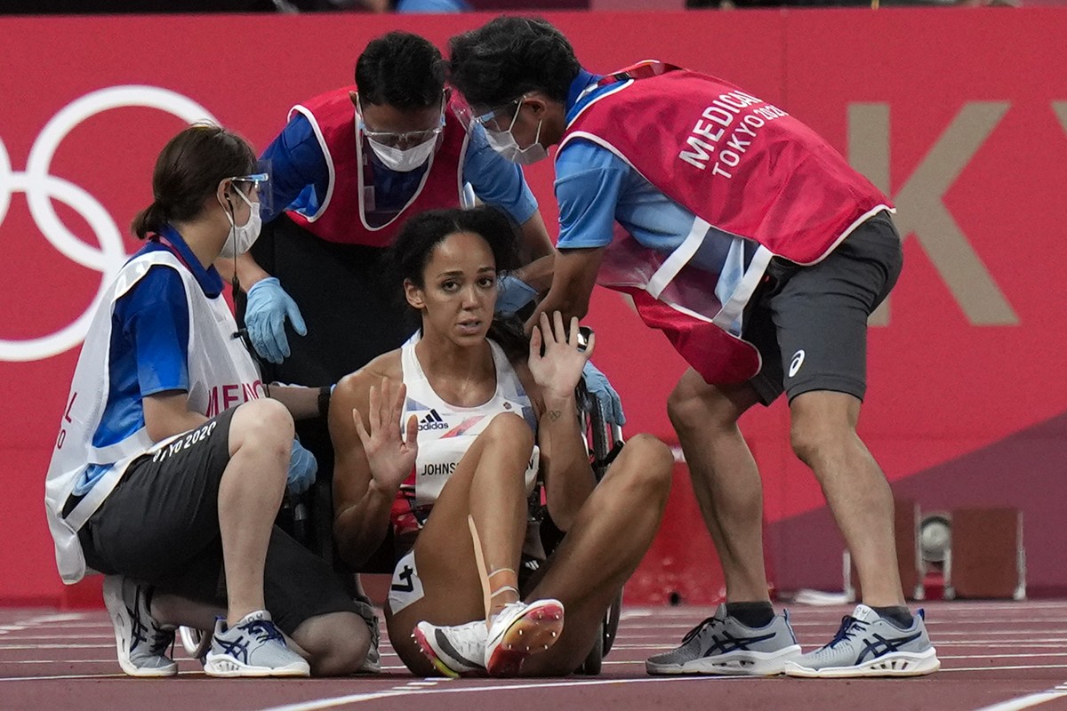 Katarina Johnson-Thompson, of Britain, reacts after dropping to the track during a heat in the heptathlon women's 200-meter at the 2020 Summer Olympics, Wednesday, Aug. 4, 2021, in Tokyo. (AP Pho ...