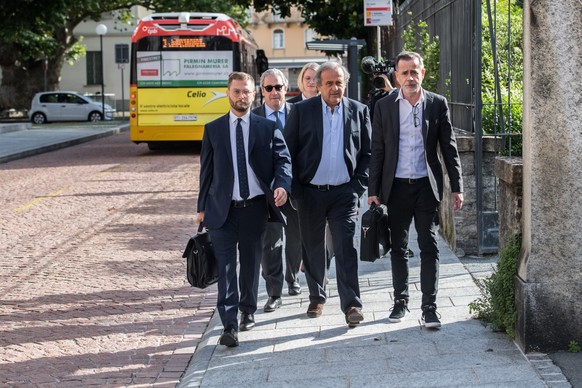 The former president of the the European Football Association (Uefa), Michel Platini, center and his lawyers arrive to the process at the Swiss Federal Criminal Court in Bellinzona, Switzerland, Wedne ...