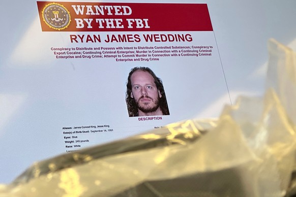 FILE - An image of former Canadian Olympic snowboarder Ryan Wedding, who is a fugitive and been charged with allegedly running and participating in a transnational drug trafficking operation, is displ ...