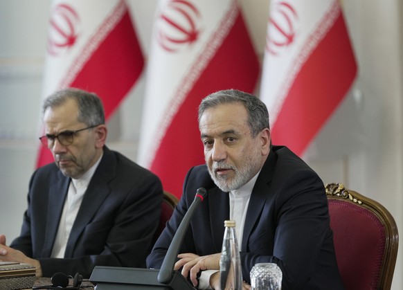 epa12234379 A handout photo made available by the Iranian foreign ministry office shows, Iranian foreign minister Abbas Araghchi (R) speaks during a meeting with foreign ambassadors and diplomats to T ...
