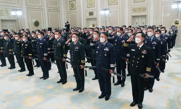 epa09584863 A group of 76 brigadier generals from the Army, Navy, Marine Corps and Air Force salute to President Moon Jae-in during a ceremony to give them the traditional Korean sword &#039;Sam Jeong ...