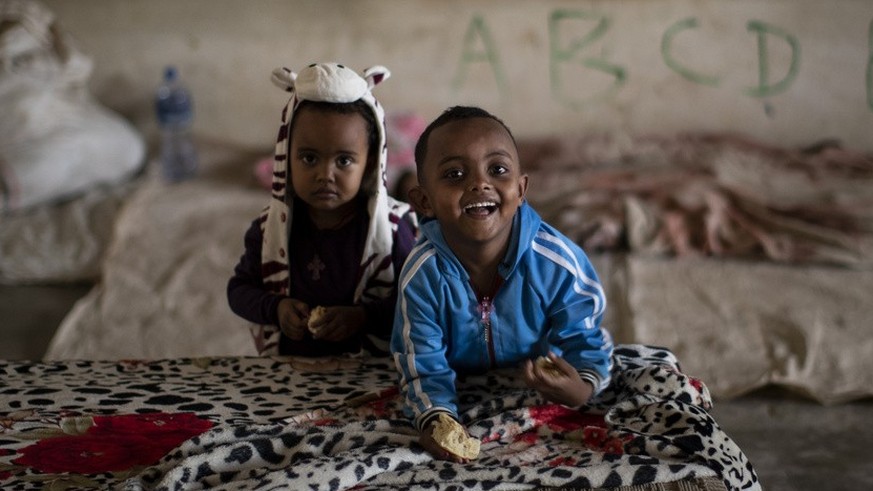 Young Tigrayan children play in a classroom where they now live at a camp for the internally-displaced in an elementary school in Mekele, in the Tigray region of northern Ethiopia Monday, May 10, 2021 ...