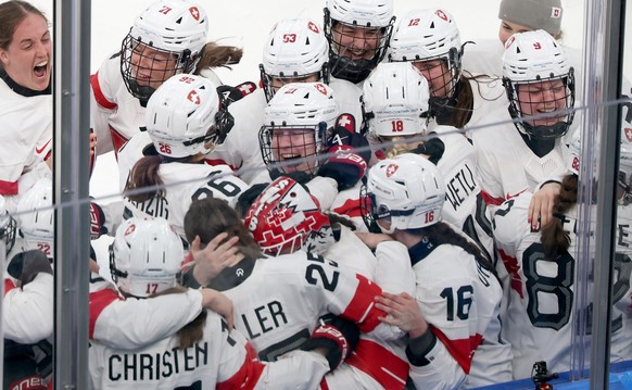 epa12758438 Alina Muller of Switzerland celebrates with her teammates after scoring the winning goal during the Women's Ice Hockey bronze medal match between Switzerland and Sweden at the Milano  ...