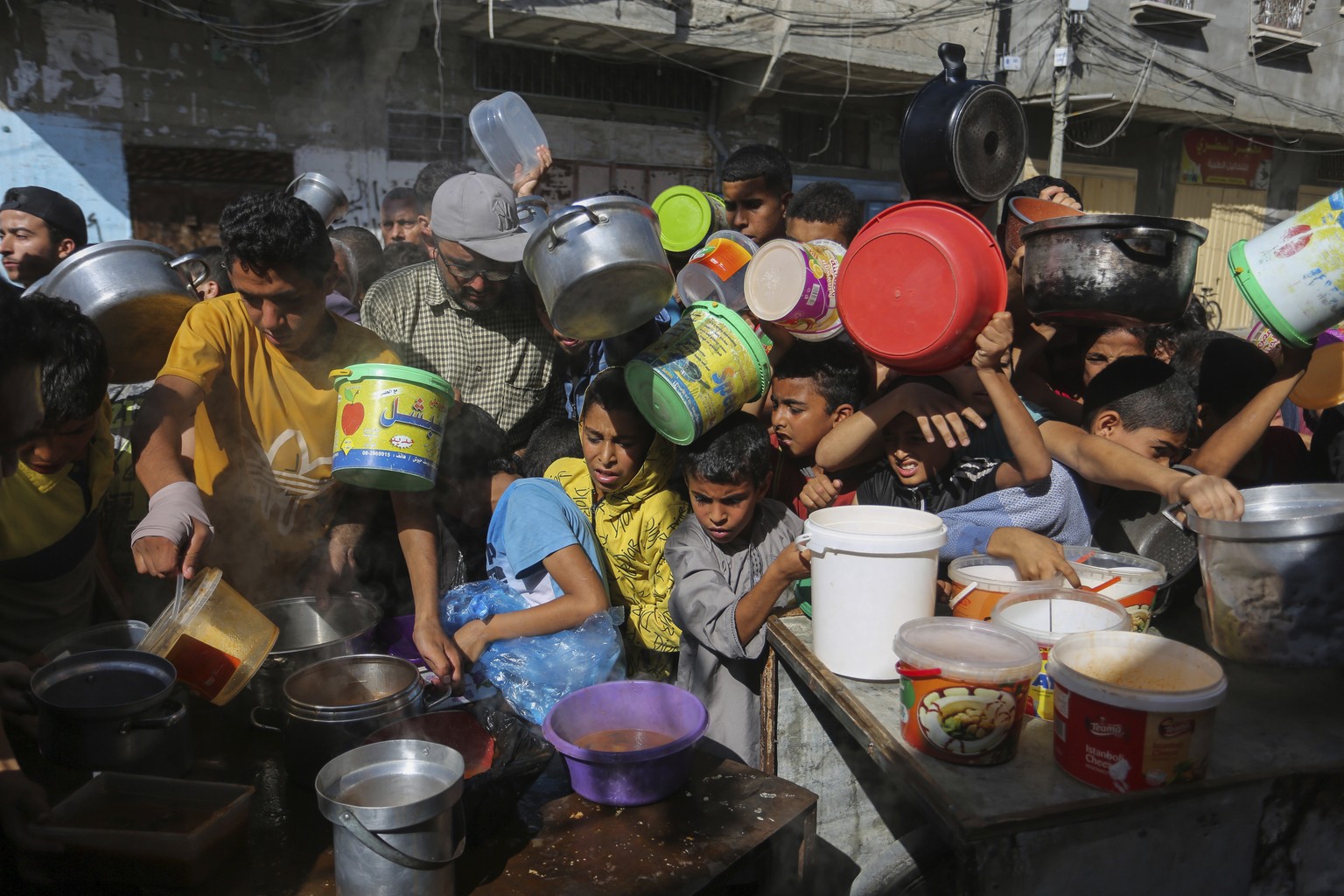 Palestinians crowded together as they wait for food distribution in Rafah, southern Gaza Strip, Wednesday, Nov. 8, 2023. Since the start of the Israel-Hamas war, Israel has limited the amount of food  ...
