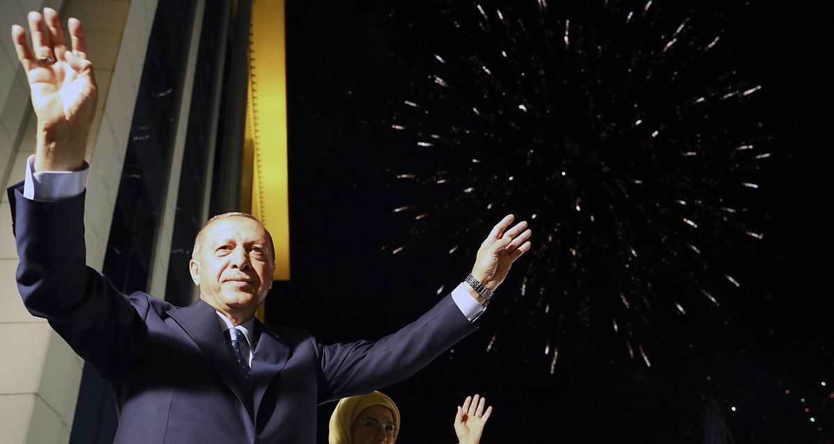 Turkey's President Recep Tayyip Erdogan, accompanied by his wife Emine waves to supporters of his ruling Justice and Development Party (AKP) in Ankara, Turkey, early Monday, June 25, 2018. Erdoga ...
