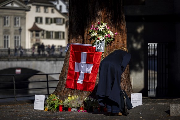 epa11631792 A woman light candles in front of the makeshift memorial for Muriel Furrer from Switzerland, who died after a cycling crash during the 2024 UCI Road and Paracycling Road World Championship ...