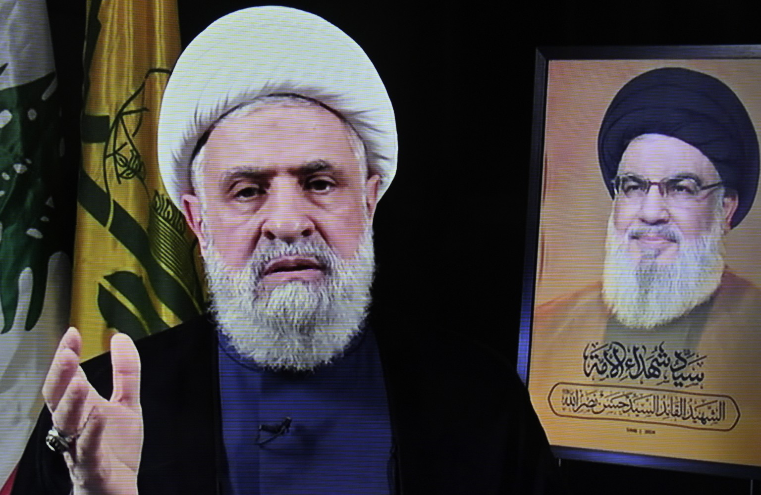epa11692456 A photo of a screen shows Hezbollah's new leader Sheikh Naim Qassem (L) delivering a televised speech broadcasted on Hezbollah's al-Manar TV channel, in Beirut, Lebanon, 30 Octob ...