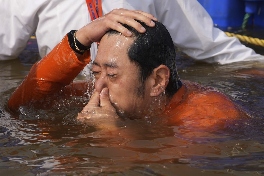 Bhutan's King Jigme Khesar Namgyel Wangchuck, takes ritualistic dips at Sangam, the confluence of rivers Ganges, Yamuna and mythical Saraswati during the Maha Kumbh festival in Prayagraj, India, ...