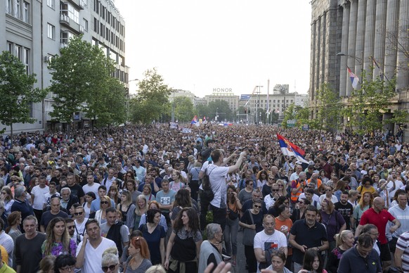 People walk down a street during a protest in Belgrade, Serbia, Saturday, June 3, 2023. Tens of thousands of people rallied in Serbia's capital on Saturday in protest of the government's han ...