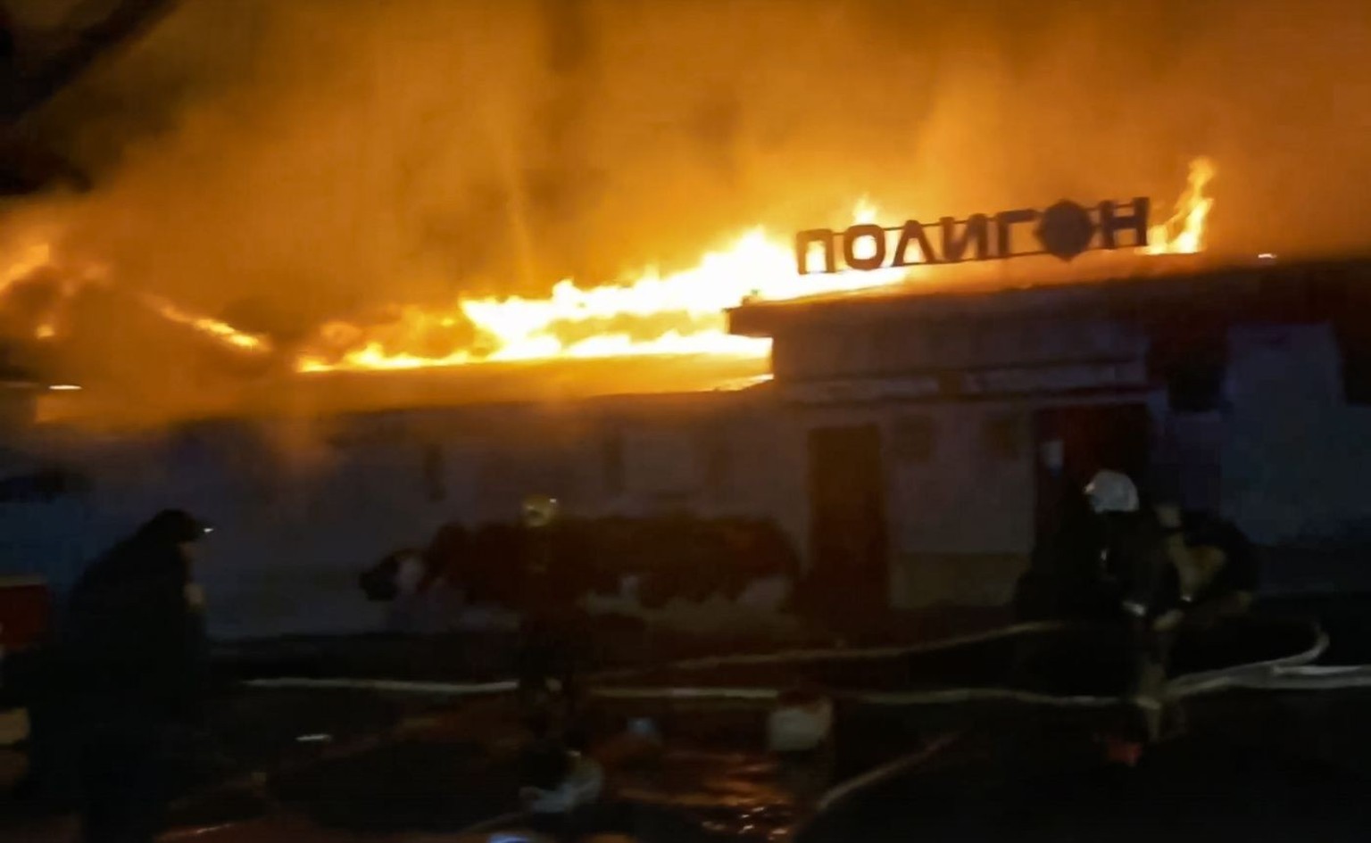 epa10287443 A handout photo taken from a video made available by the Russian Emergency Ministry Press Service shows firefighters try to extinguish a fire at 'Polygon' cafe in Kostroma, Russi ...