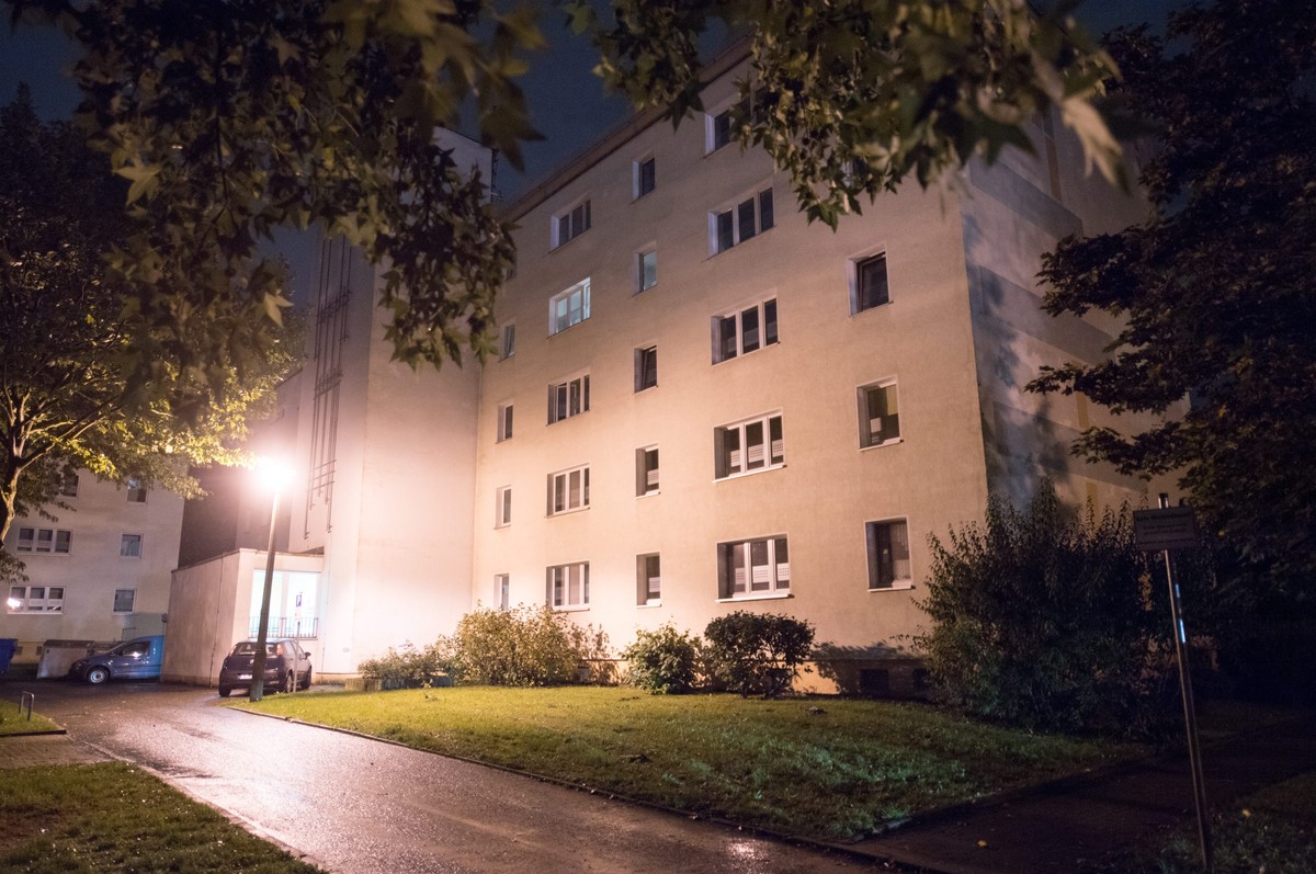 epa05576974 Floodlights illuminate a block of flats in a residential area of Chemnitz, Saxony, Germany, 08 October 2016. A large police operation has been underway in the area and have detained three  ...