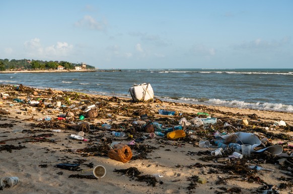 KOH SAMUI, THAILAND - December 15, 2019: Beach pollution such as Plastic bottles and other trash on sea beach in Koh, KOH SAMUI, THAILAND - December 15, 2019: Beach pollution such as Plastic bottles a ...