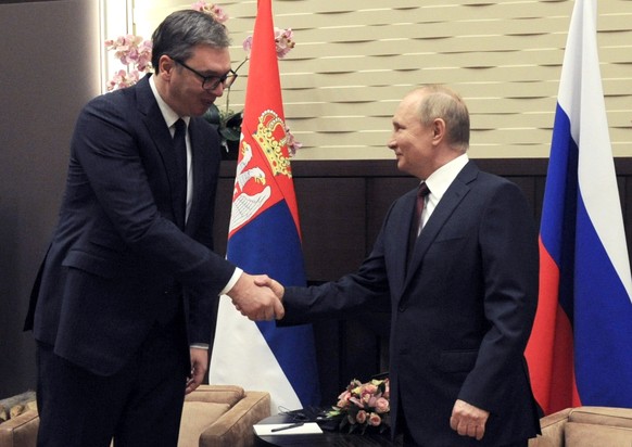 epa09602395 Russian President Vladimir Putin (R) and his Serbian counterpart Aleksandar Vucic (L) shake hands during a meeting in the Black Sea resort of Sochi, Russia, 25 November 2021. Vucic is on a ...