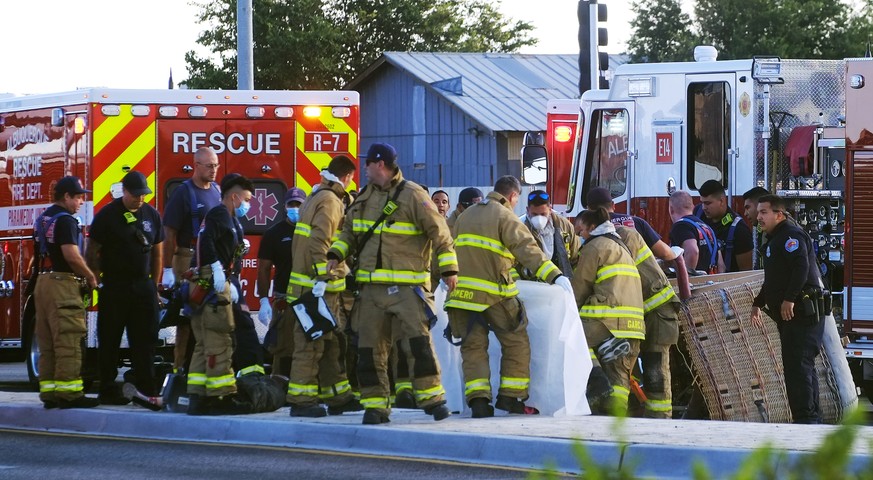 Albuquerque Fire Rescue crews work on victims of the fatal balloon crash at Unser and Central SW in Albuquerque, N.M., on Saturday, June 26, 2021. Multiple people were killed in the crash. (Adolphe Pi ...