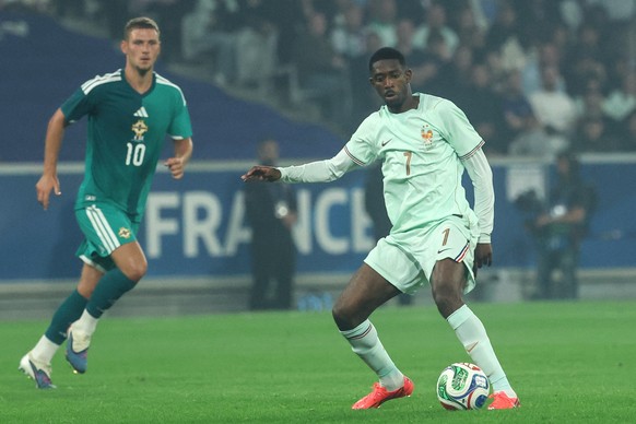 epa13025183 Ousmane Dembele of France (R) in action against Jamie Donley (L) of Northern Ireland during the international friendly soccer match between France and Northern Ireland in Lille, France, 08 ...