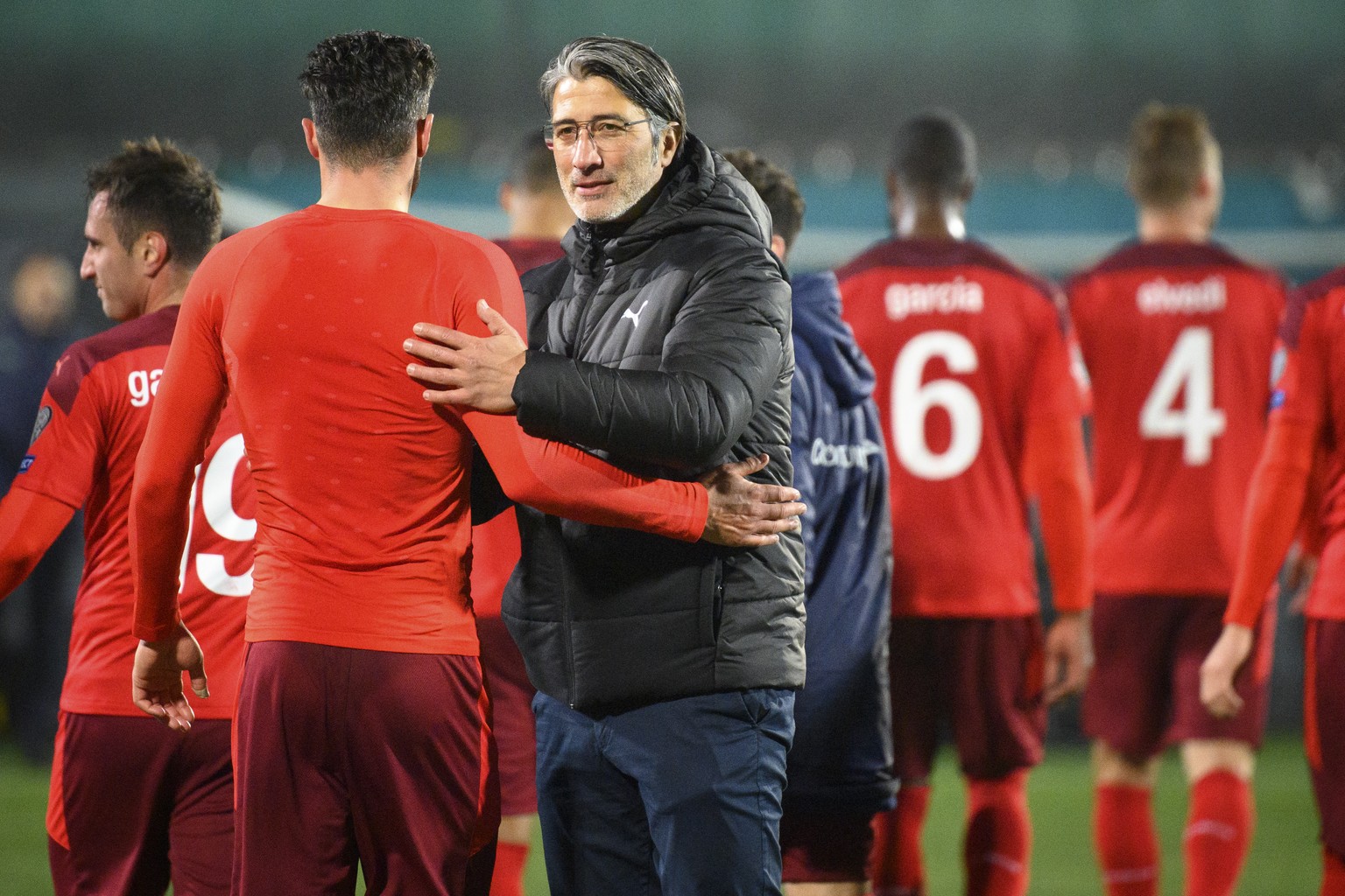 Switzerland's head coach Murat Yakin congratulates his players after the 2022 FIFA World Cup European Qualifying Group C soccer match between Lithuania and Switzerland at LFF stadium in Vilnius, Lithu ...