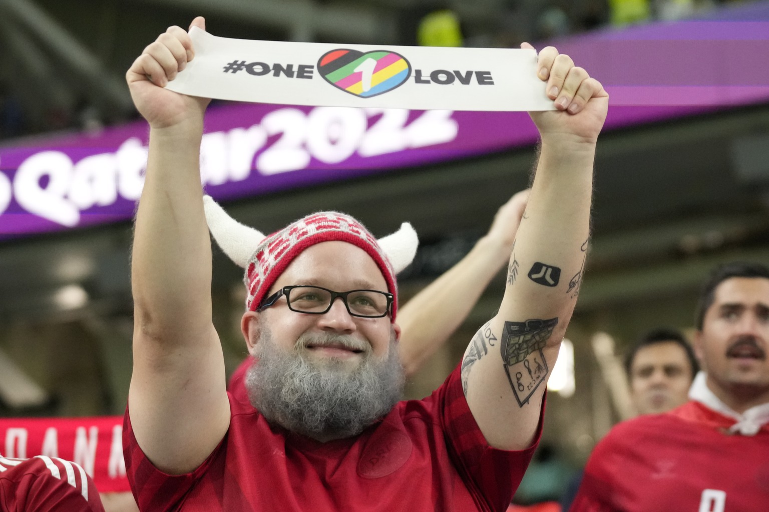 A Danish fan displays &#039;one love&#039; banner before wearing it on his arm before the World Cup group D soccer match between Australia and Denmark, at the Al Janoub Stadium in Al Wakrah, Qatar, We ...