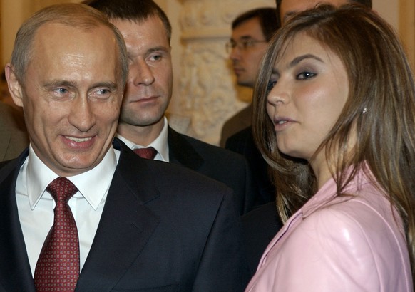 FILE - In this Thursday, Nov. 4, 2004 file photo President Vladimir Putin, left, speaks with gymnast Alina Kabaeva at a Kremlin banquet in Moscow, Russia. (AP Photo/ITAR-TASS, Presidential Press Servi ...