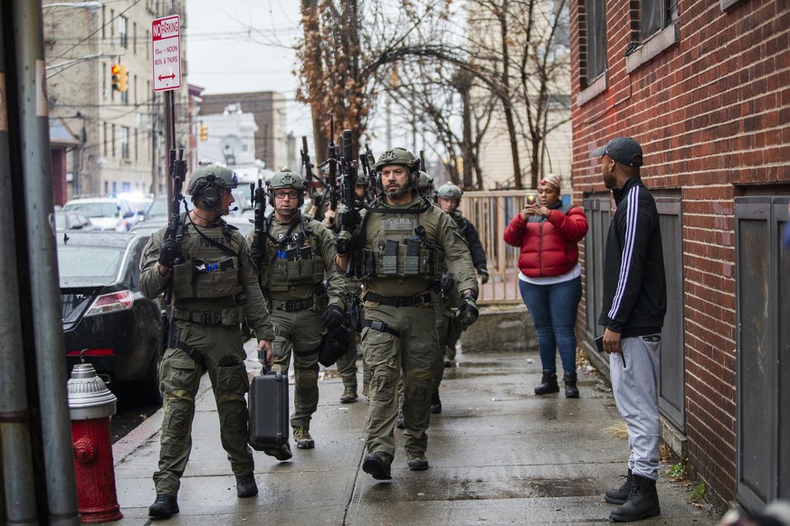 Police officers arrive at the scene following reports of gunfire, Tuesday, Dec. 10, 2019, in Jersey City, N.J. AP Photo/Eduardo Munoz Alvarez)
