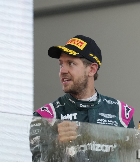 First place, Red Bull driver Sergio Perez of Mexico, center, celebrates on the podium with second place, Aston Martin driver Sebastian Vettel of Germany, left, and third place, AlphaTauri driver Pierr ...