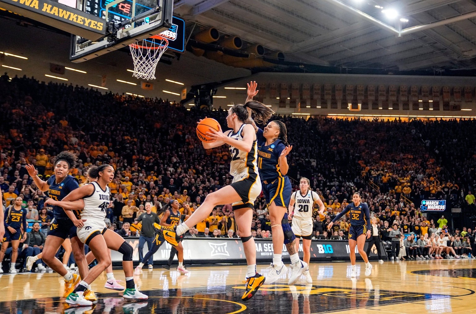 Syndication: The Des Moines Register Iowa Hawkeyes guard Caitlin Clark 22 grabs a rebound in a second-round NCAA, College League, USA Tournament game between Iowa and West Virginia, Monday, March 25,  ...
