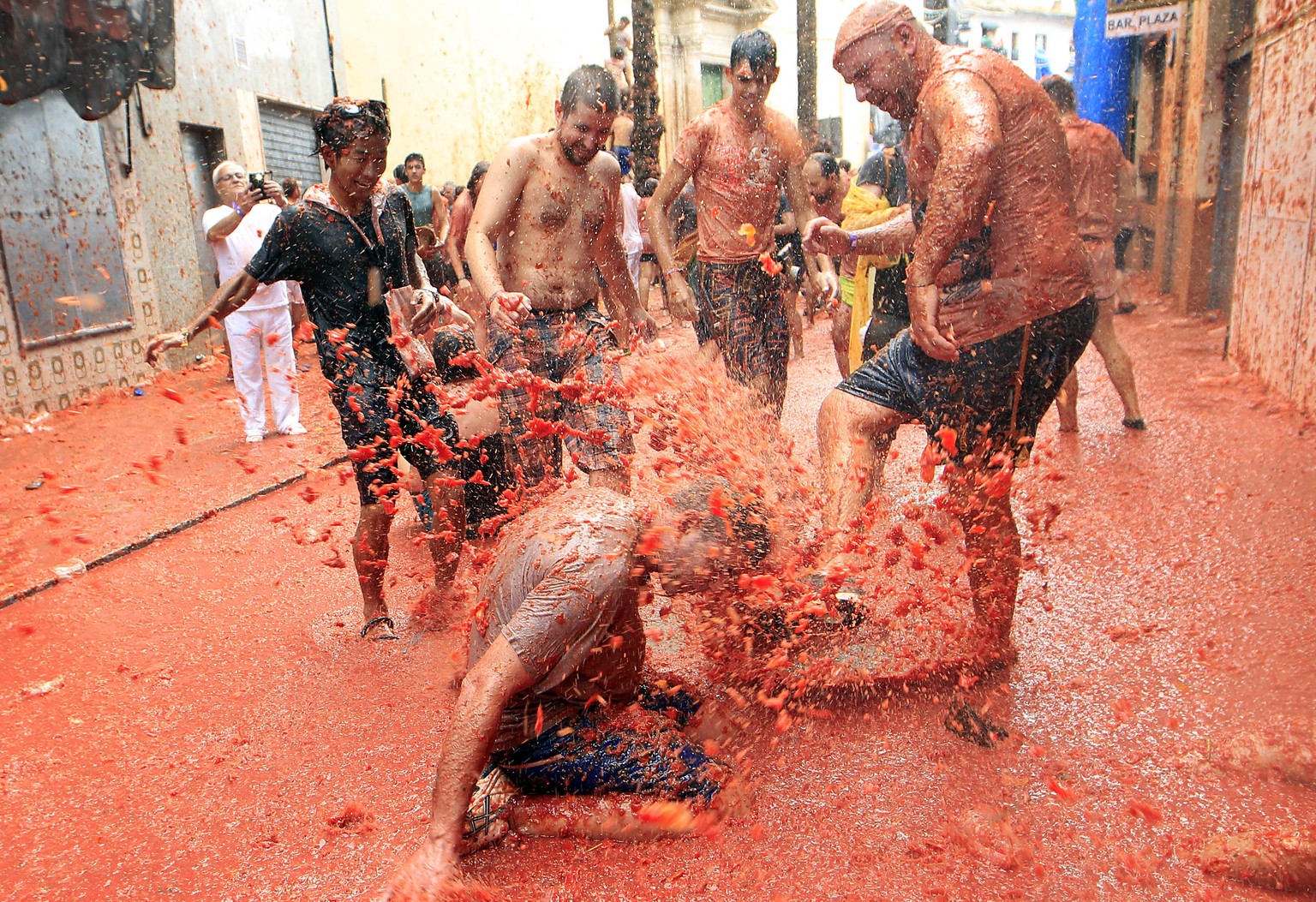 Revelers enjoy as they throw tomatoes at each other, during the annual &quot;Tomatina&quot;, tomato fight fiesta, in the village of Bunol, 50 kilometers outside Valencia, Spain, Wednesday, Aug. 30, 20 ...