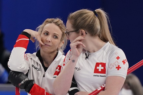 Switzerland&#039;s Silvana Tirinzoni, left, and Alina Paetz interact during a women&#039;s curling semifinal match between Japan and Switzerland at the Beijing Winter Olympics Friday, Feb. 18, 2022, i ...