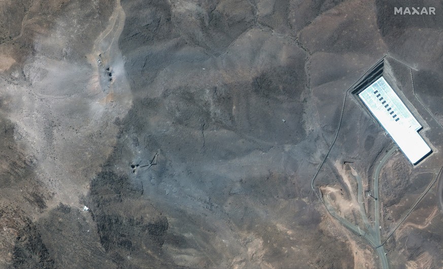 This satellite image provided by Maxar Technologies shows a closer view of craters and ash on a ridge at Fordo enrichment facility in Iran after U.S. strikes, Sunday, June 22, 2025. (Maxar Technologie ...