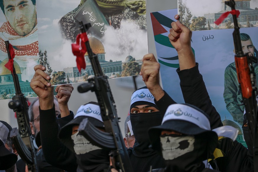 epa10359285 Fighters belonging to the Lion&#039;s Den group of the Al-Qassam brigades march during the preparations for the 14 December celebrations of the 35th founding anniversary of Hamas, in the n ...