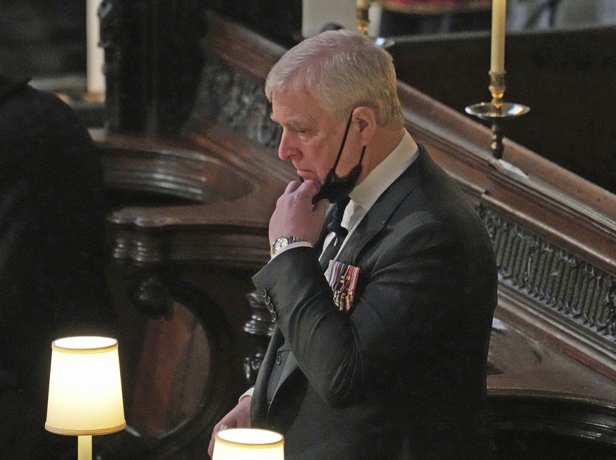FILE - Britain's Prince Andrew stands inside St. George's Chapel during the funeral of his father, Prince Philip, at Windsor Castle, Windsor, England, Saturday April 17, 2021. Longtime Jeffrey Epstein ...
