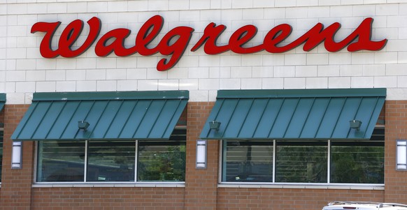 FILE - This June 21, 2013 file photo shows the script &quot;Walgreens&quot; over windows at the store in Wexford, Pa. The Federal Trade Commission wants more information about Walgreens $9.41-billion ...