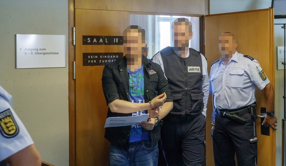 epa06932111 Defendants Christian L. (L) leaves after the judgement on sexual abuse of a minor at the regional court in Freiburg, Germany, 07 August 2018. Christian L. and Berrin T. are accused of havi ...