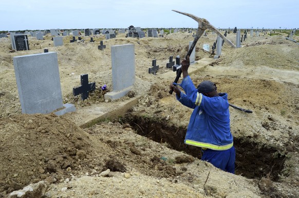 A grave digger prepares graves at the Motherwell Cemetery in Port Elizabeth, South Africa, Friday, Dec. 4, 2020. Health Minister Zweli Mkhize announced on Wednesday, Dec. 9, 2020 that the country is n ...