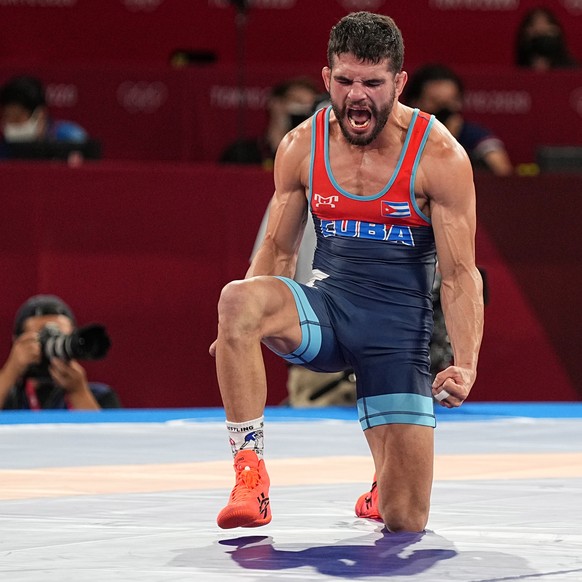 epa09388501 Gold medalist Luis Alberto Orta Sanchez of Cuba reacts after defeating Silver medalist Kenichiro Fumita of Japan at the end of the Men&#039;s Greco-Roman 60kg Final Match of the Tokyo 2020 ...