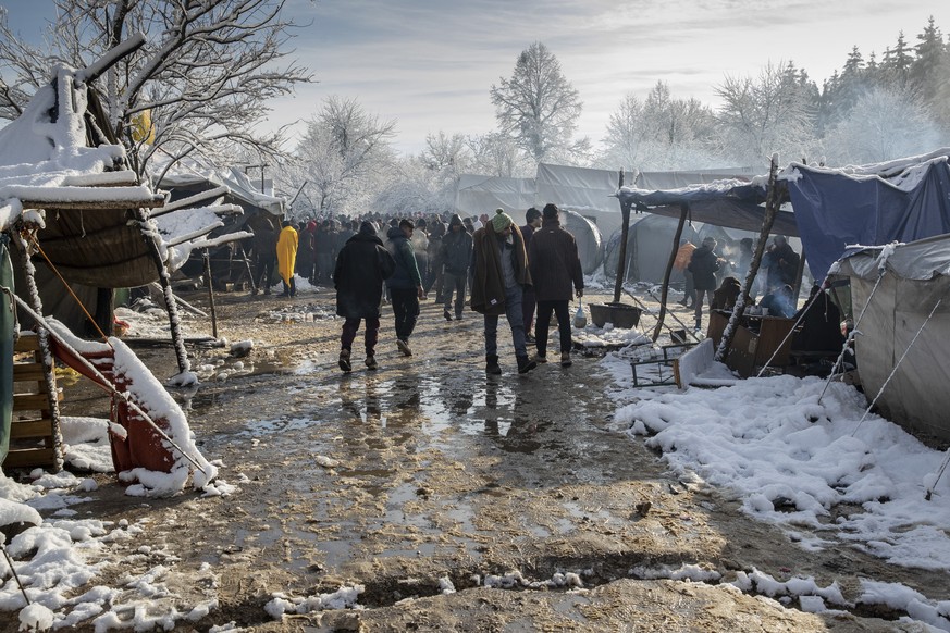 Migrants gather at the Vucjak refugee camp outside Bihac, northwestern Bosnia, Tuesday, Dec. 3, 2019. A European human rights official has demanded immediate closure of a migrant camp in Bosnia where  ...