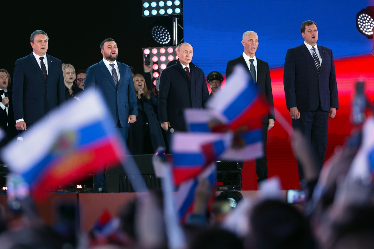 Russian President Vladimir Putin, center, speaks as Leonid Pasechnik, leader of self-proclaimed Luhansk People's Republic, left, Denis Pushilin, leader of self-proclaimed of the Donetsk People  ...