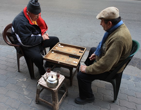 simple symetric pleasures: two friends, two tea, two charis &amp; one backgammon set on a sidewalk in Salihiya, Damascus (27.12.2009)