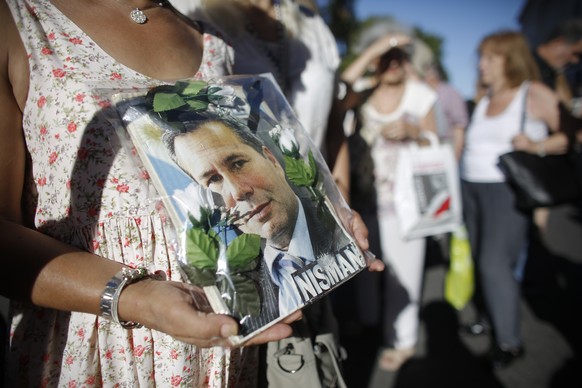 A person holds a photo of late prosecutor Alberto Nisman during a demonstration on the second-year anniversary of his death in Buenos Aires, Argentina, Wednesday, Jan. 18, 2017. Nisman was found dead  ...