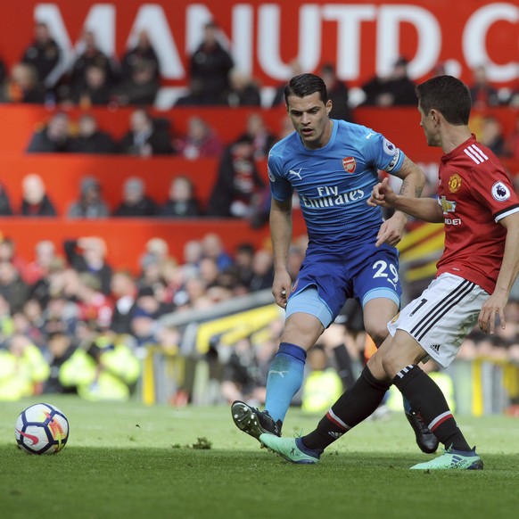 Arsenal&#039;s Granit Xhaka, left, duels for the ball with Manchester United&#039;s Ander Herrera during the English Premier League soccer match between Manchester United and Arsenal at the Old Traffo ...